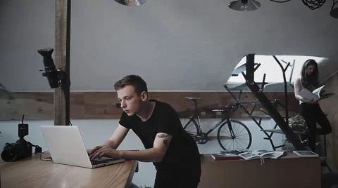 Young man working in photo studio Stock Footage 64566681