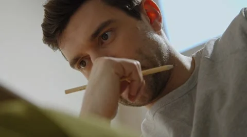 Young man working on a project, drawing and thinking close up Stock Footage 45429898