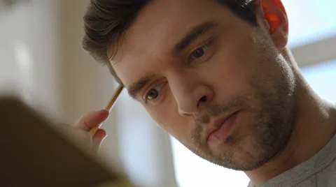 Young man working on a project, drawing and thinking super close up Stock Footage 45429918