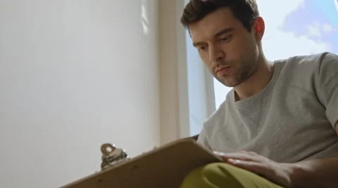 Young man working on a project, drawing and thinking Stock Footage 45429961