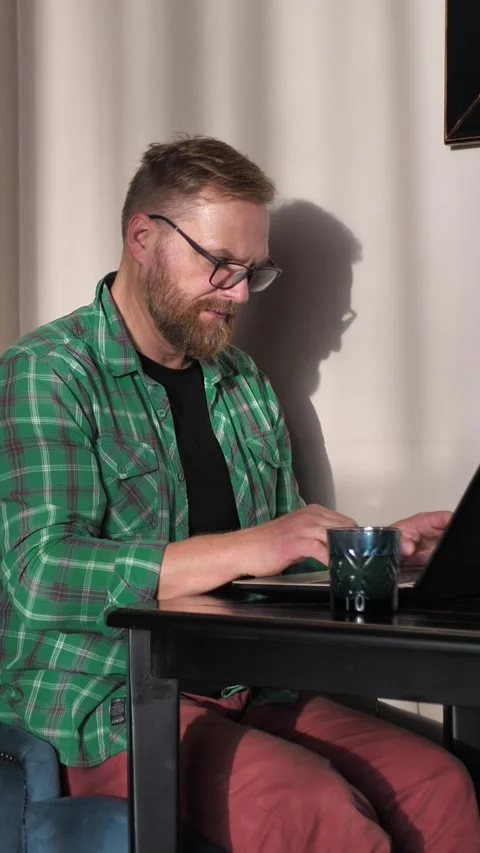 Young man working remotely using laptop at home. Stock Footage 307388404