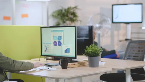 Young man working in start-up office at computer workstation Stock Footage 149243383