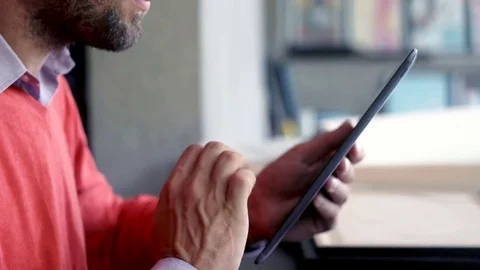 Young man working with tablet and laptop by table at home Stock Footage 82170877