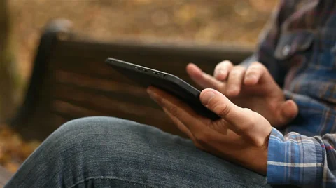 Young man working on tablet computer in city park, 1080p Stock Footage 28506681