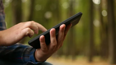 Young man working on tablet computer in city park, 1080p Stock Footage 28507663