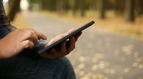 Young man working on tablet computer in city park, 1080p Stock Footage 28508005