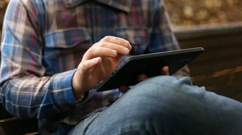 Young man working on tablet computer in city park, 1080p Stock Footage 28510037