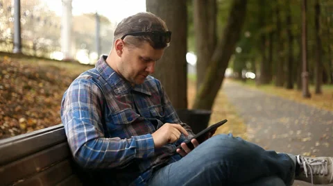Young man working on tablet computer in city park, 1080p Stock Footage 28510271