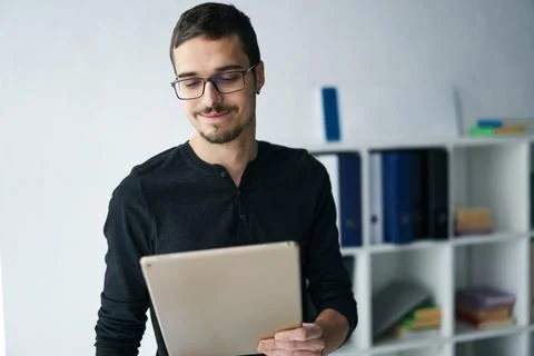 Young man working with tablet, receiving video call, talking with partners Stock Photos
