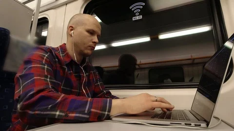 A young man working in the train at night on the computer. Stock Footage 122704328