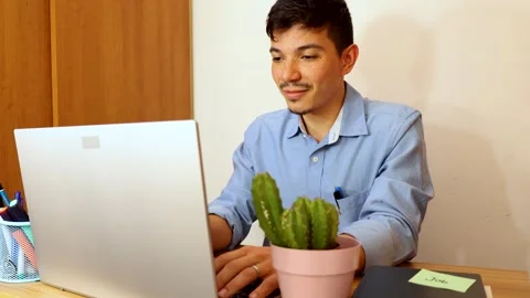 Young man working typing on computer in his office Stock Footage 292618333