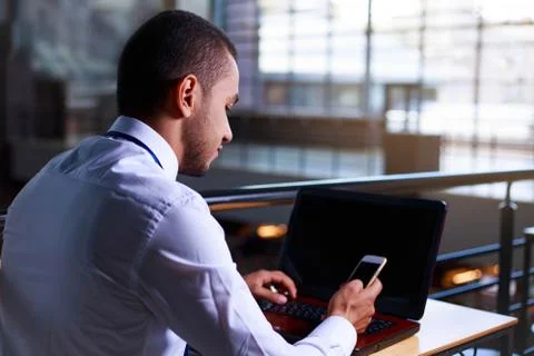 Young man working using smart phone and notebook computer, man's hands using Foto stock
