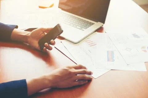 Young man working using smartphone and notebook computer, Young man work and Foto stock