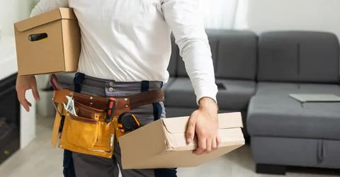 Young man working at a warehouse with boxes Stock Photos