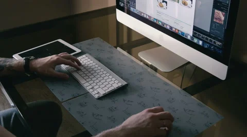 Young man works on the computer and a tablet Stock Footage 62065757