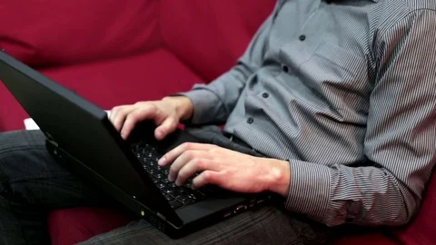 Young man works at a computer in an informal atmosphere Stock Footage 72171391