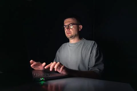 Young man works at the computer at night. Stock Photos