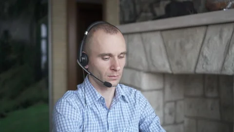 A young man works at a computer. Telework. Work from home. Stock Footage 147564108