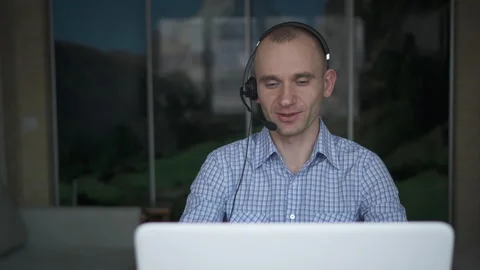 A young man works at a computer. Telework. Work from home. Stock Footage 147566325