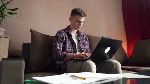 A young man works from home on a computer. quarantine. cozy room Stock Footage 208876993