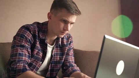 A young man works from home on a computer. quarantine, isolation. Stock Footage 212608164