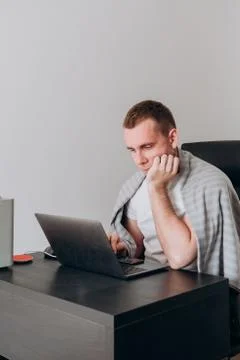 A young man works at home at a computer in quarantine Stock Photos