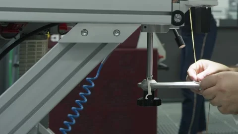 A young man works at a machine in the workshop Stock Footage 251792620