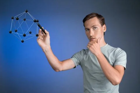 Young man works on a model of molecule Stock Photos