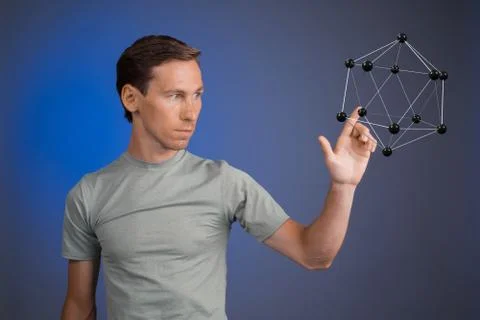 Young man works on a model of molecule Stock Photos