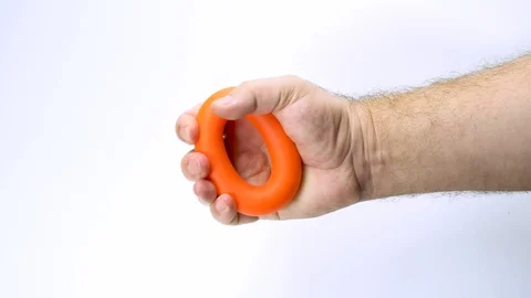 Young man works with the orange expander by hand on white background Stock Footage 127698697
