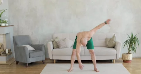 A young man works out doing exercise at home. Front view. Stock Footage 152784745