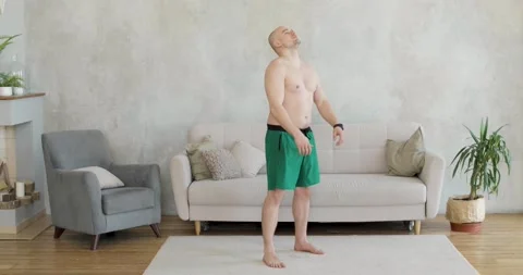 A young man works out doing exercise at home. Stock Footage 152785200