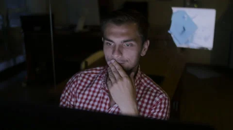 The young man works over the construction plan of the house Stock Footage 58014812