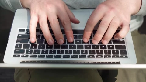 A young man works remotely at a computer in the fresh air. Stock Footage 241493131
