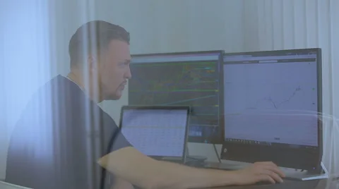 The young man works at three computers at once Stock Footage 62519141