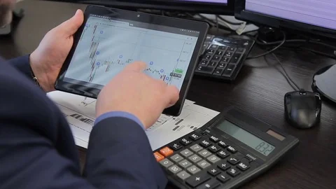 Young man works, using tablet and calculator in leading company. Stock Footage 85448620