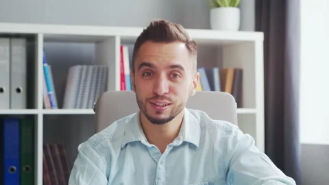 Young Man Works while Sitting in front of a Computer at Home. The Workplace of a Stock Footage 194529995