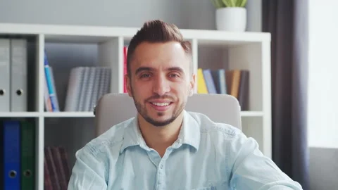 Young Man Works while Sitting in front of a Computer at Home. The Workplace of a Stock Footage 194949544