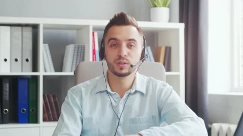 Young Man Works while Sitting in front of a Computer at Home. The Workplace of a Stock Footage 199289249