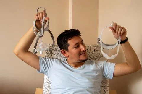 Young man is worried about using nasal CPAP mask Stock Photos