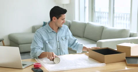 Young man wrapping cups for gift prepare parcel for sending 스톡 동영상 249865643