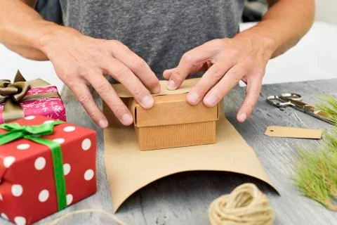Young man wrapping a gift Stockfoto's