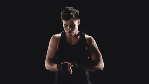 Young man wrapping hands with boxing wraps Stock Footage 152116148