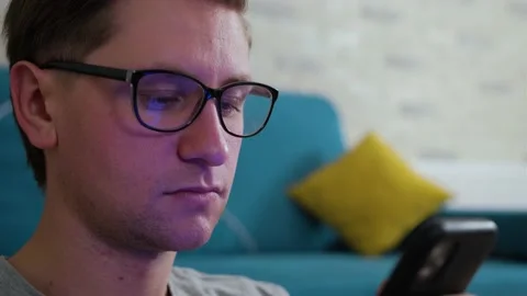 Young man write a message using a mobile phone, staying isolated at home. Stock Footage 144196294