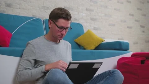 Young man write a message using a laptop, staying isolated at home. Stock Footage 144384324