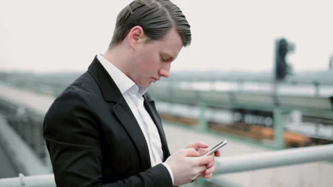 Young man writes messages on his mobile phone. Stock Footage 117674080