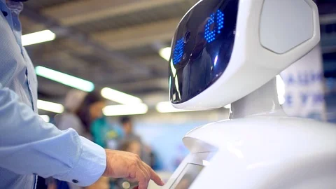 A young man writes on a robot display. Stock Footage 86450223