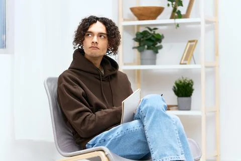 A young man writing down ideas with a notepad isolated background Foto stock