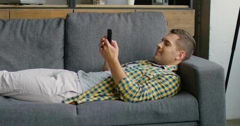Young man is writing a message on his smartphone Stock Footage 113615093