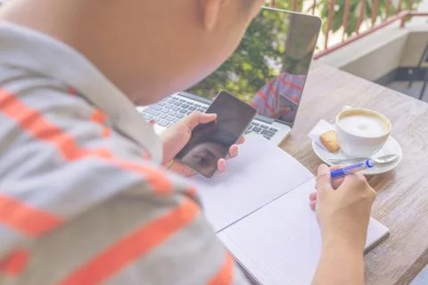 Young man writing on notebook or document Foto stock